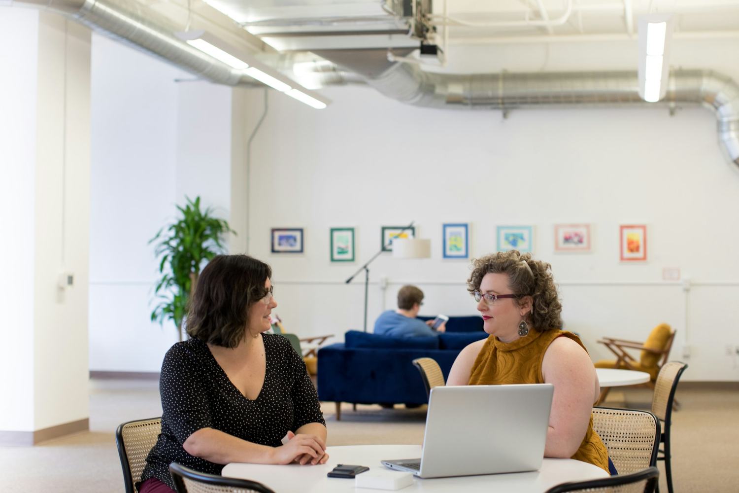 Two people in a quiet conversation across a table