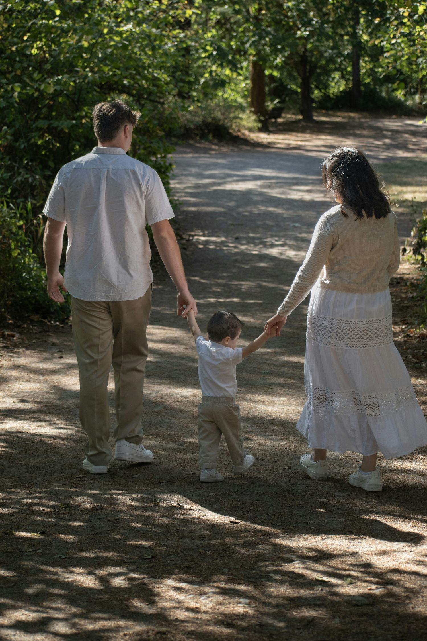 A family walking together along a woodland path