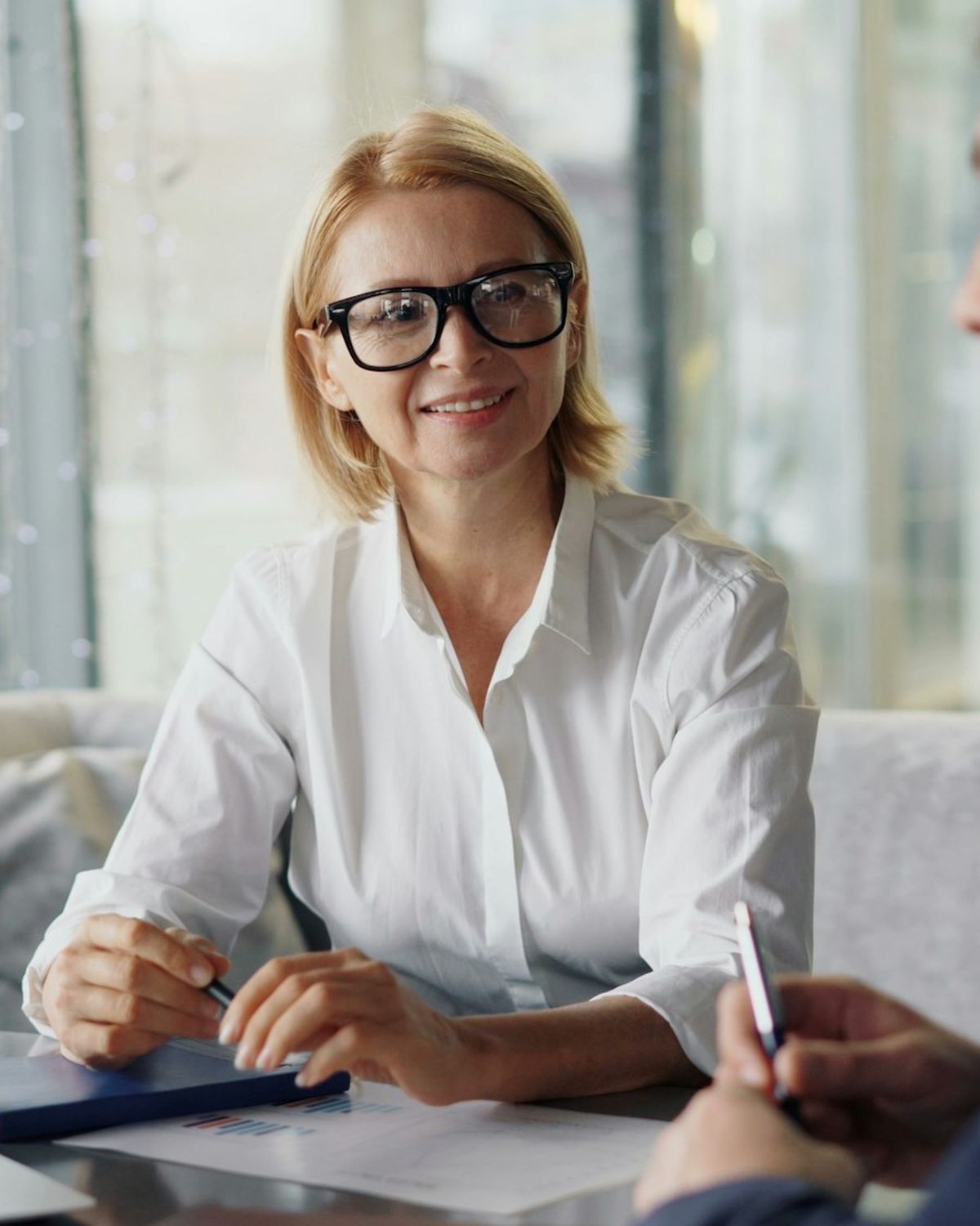 A solicitor talking through a client's options at a table in a bright office